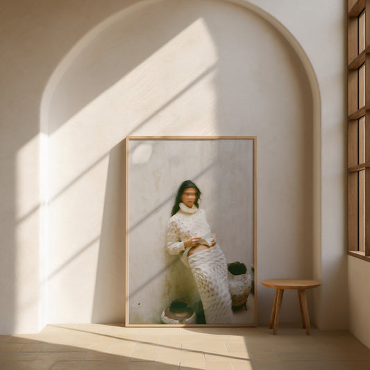 Analog fashion portrait print of woman in textured cream knit outfit with motion blur, shot on 120mm film, displayed in a wooden frame in a sunlit minimalist arch interior