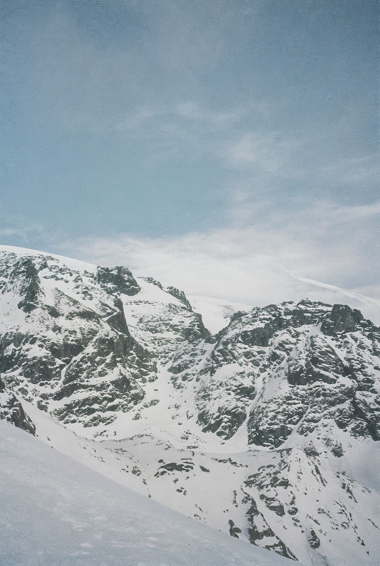 Analog film photograph of the Breithorn mountain in the Swiss Alps, soft winter light falling across snow-covered peaks — first in a three-part series.