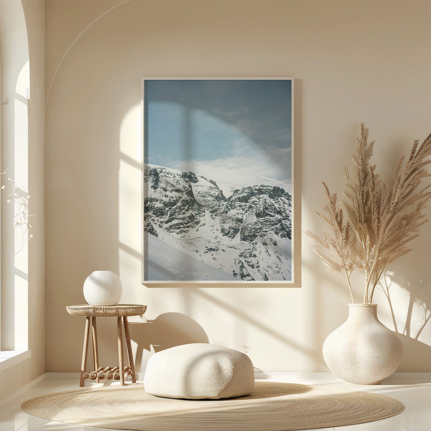 Minimalist interior with a framed snow-covered mountain landscape print in soft blue tones, styled above a wooden console with ceramic vases and natural light, fine art analog photography print shot on 35mm film
