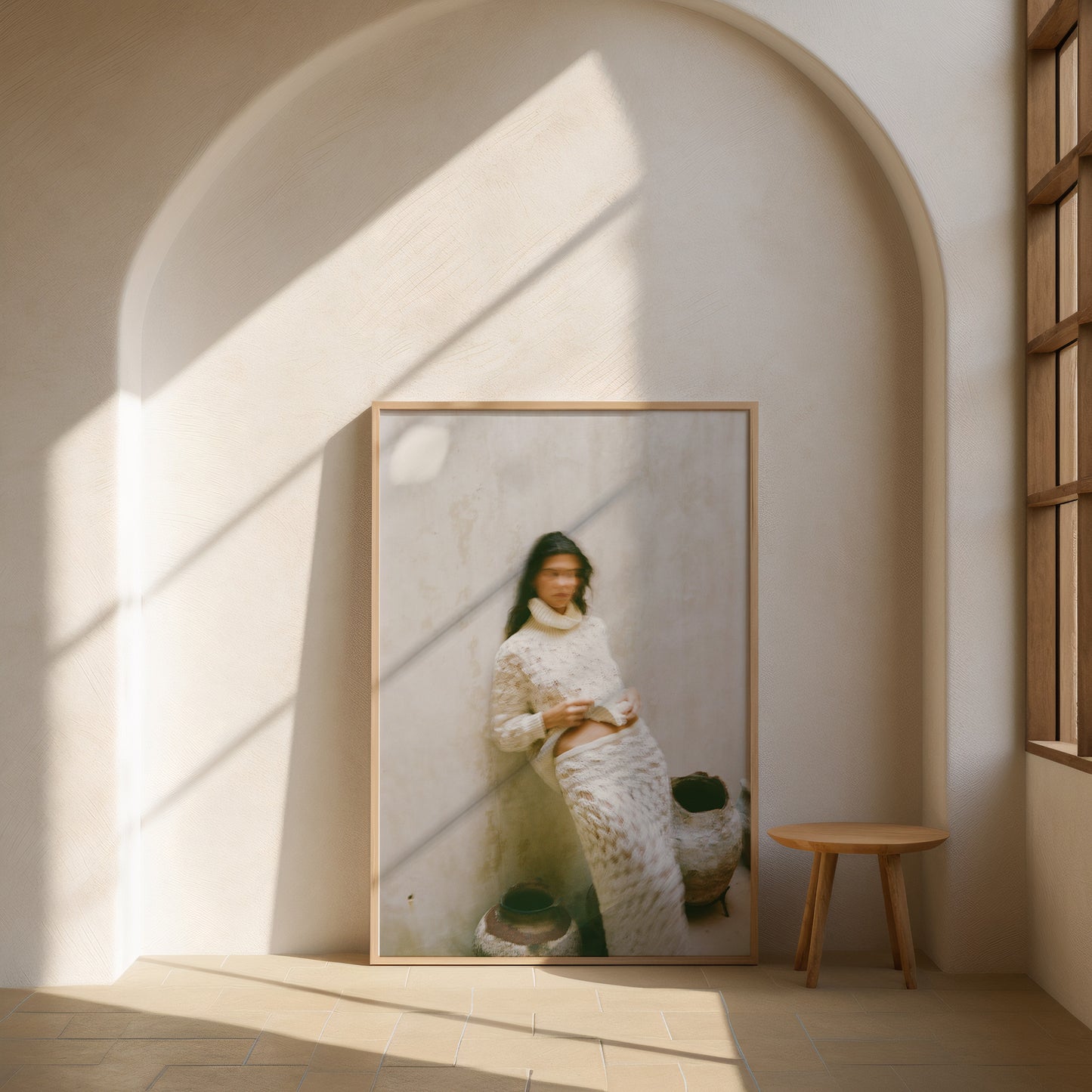 Analog fashion portrait print of woman in textured cream knit outfit with motion blur, shot on 120mm film, displayed in a wooden frame in a sunlit minimalist arch interior