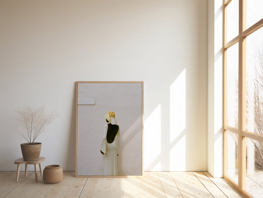 framed print Analog fashion portrait of woman in open back cream dress and straw hat shot on 35mm film against minimalist white wall in warm natural light