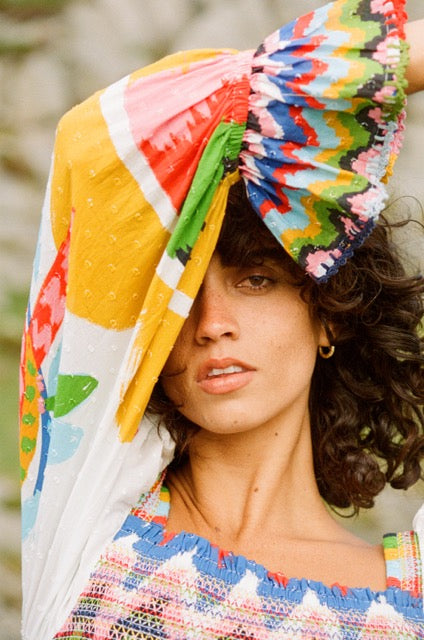 Analog fashion portrait of Shanti wearing Farm Rio in Norway, with colorful patterned fabric draped over her head, shot on medium format film