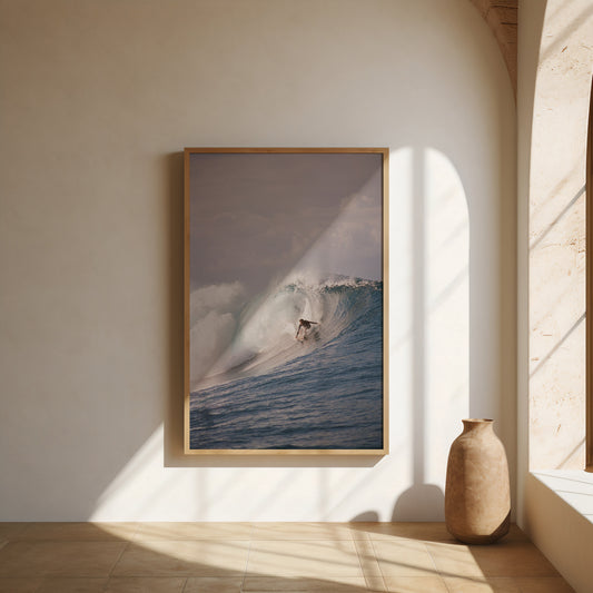 Analog film photograph of a surfer paddling through soft tropical light, captured on 35mm film in summer tones. Framed in a beautiful minimal setting.