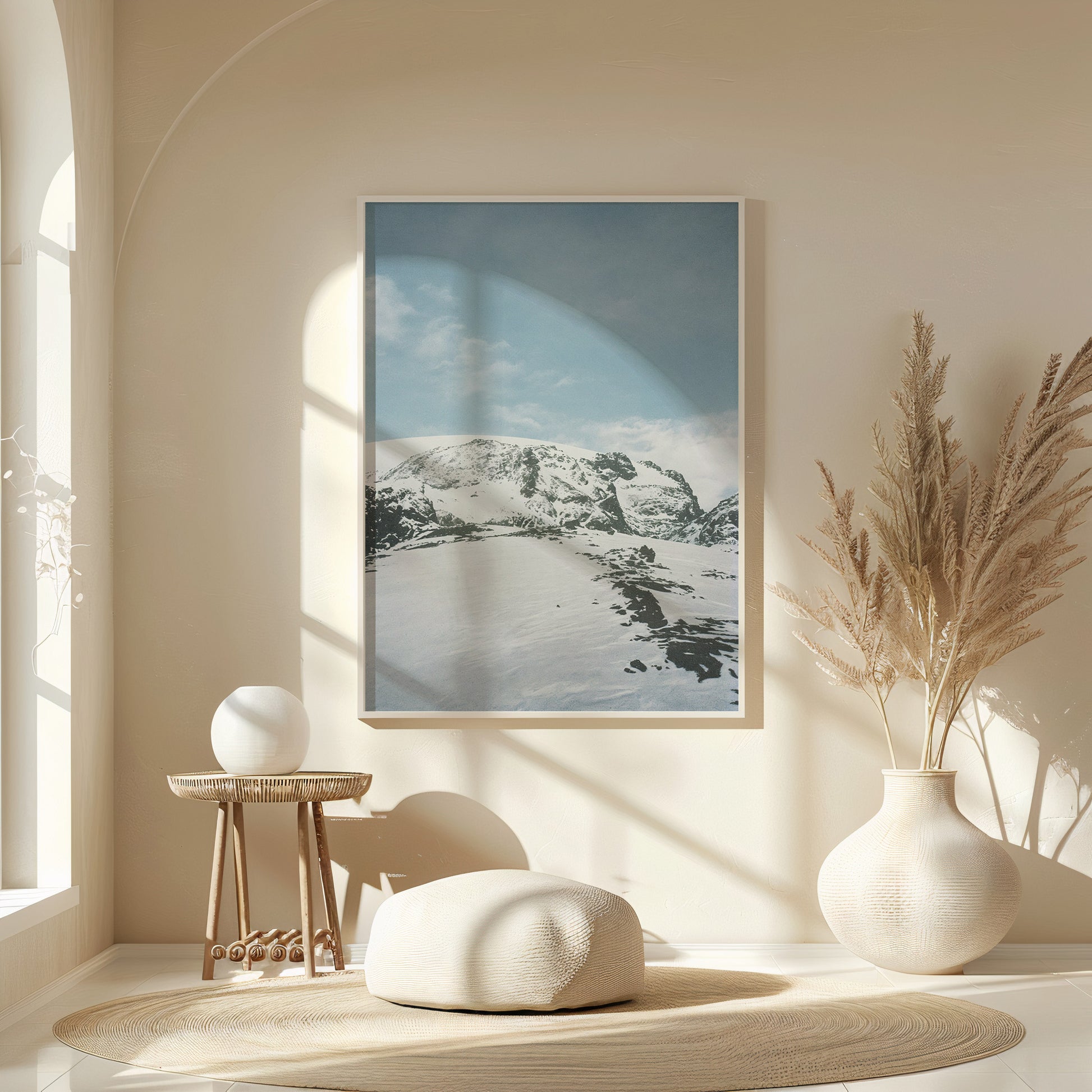 Minimalist interior with a framed snow-covered mountain landscape print in soft blue tones, styled above a wooden console with ceramic vases and natural light, fine art analog photography print shot on 35mm film
