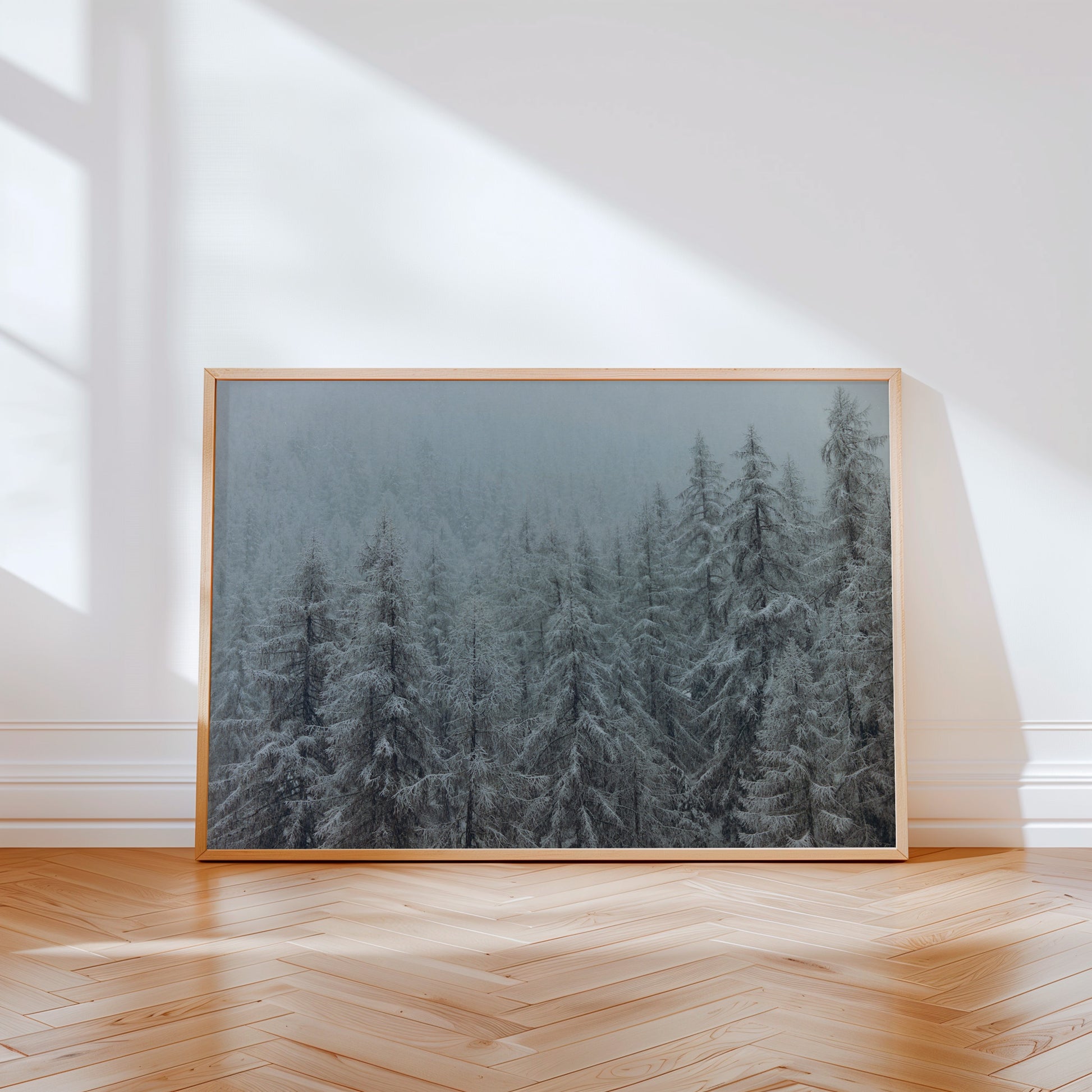 Analog winter forest landscape print of snow covered alpine trees in mist, shot on 35mm film in the Swiss Alps with soft muted tones